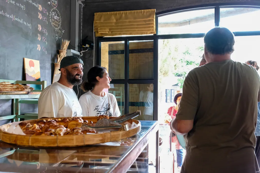 Owners welcoming a guest at the counter
